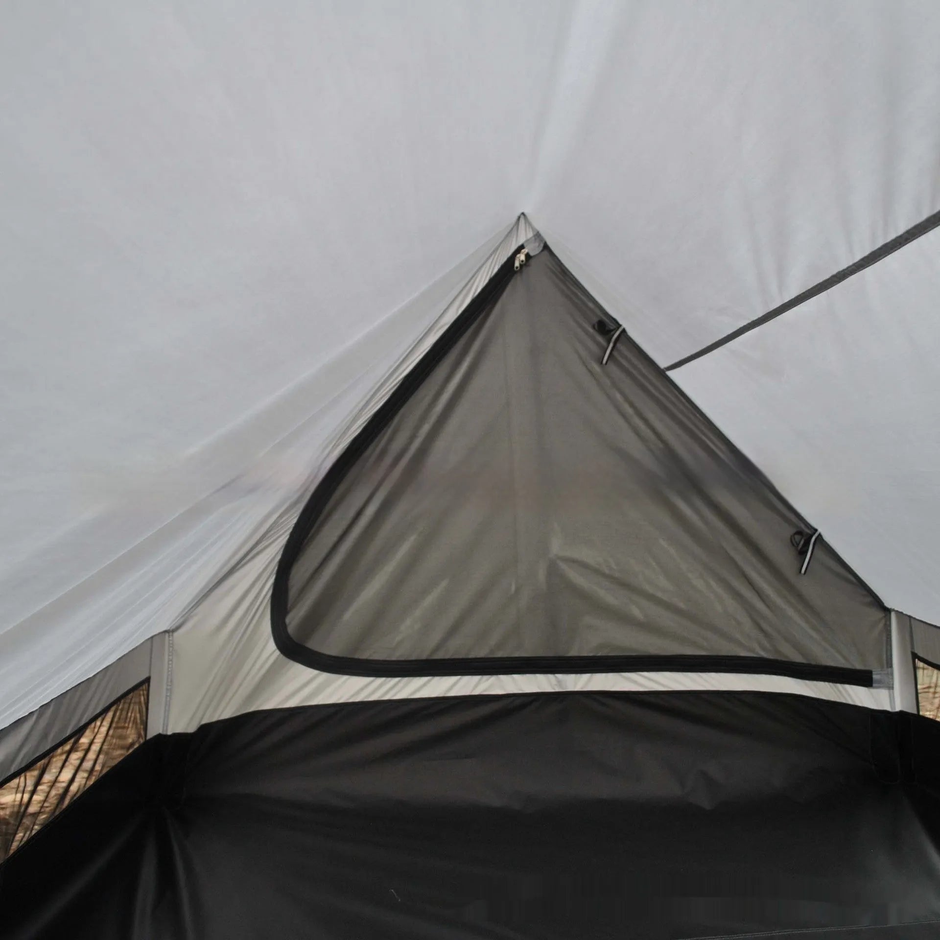 Brown A-line hiking tent erected with hiking poles showing spacious interior for 2-3 people