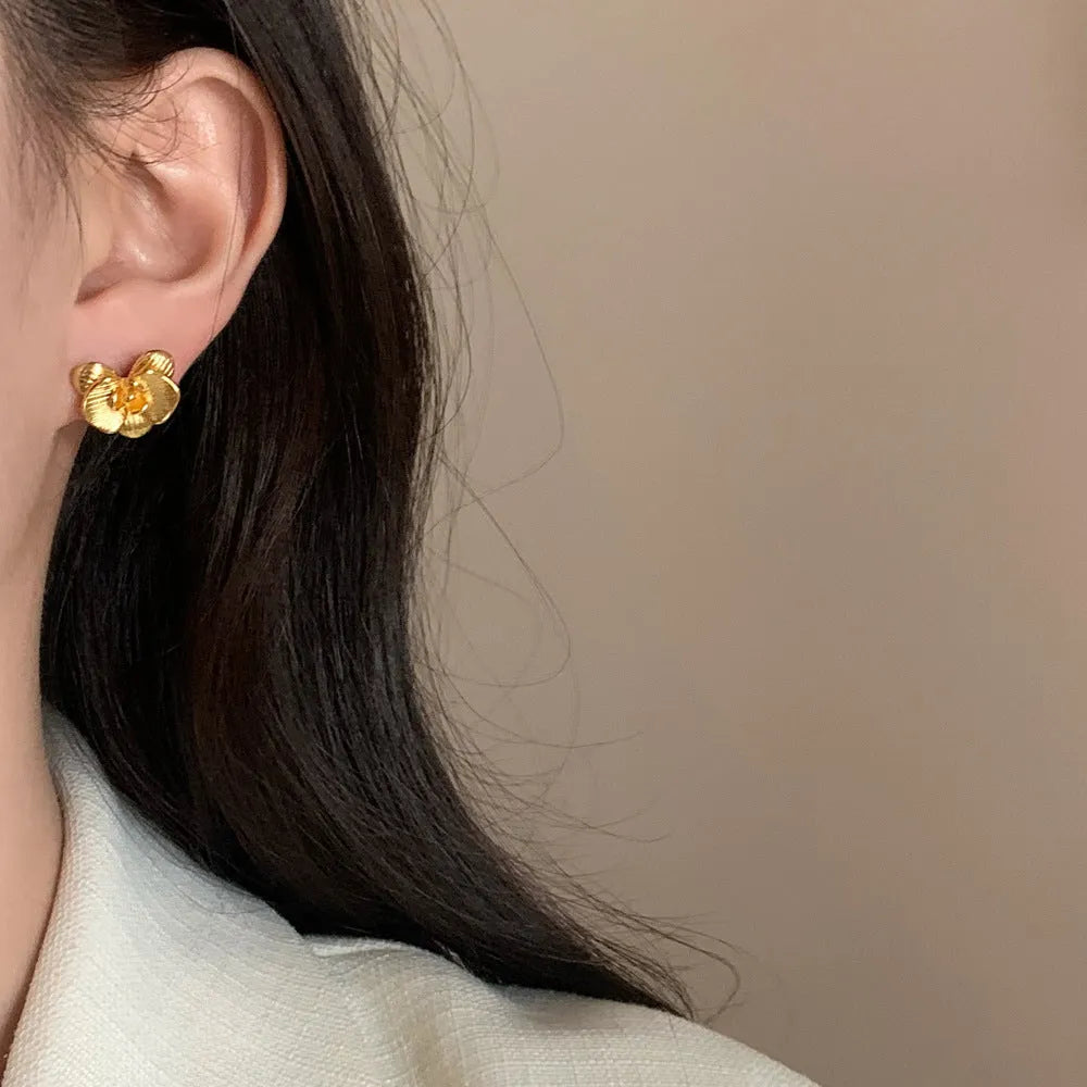 Retro style flower earrings for women in gold or silver finish with petal detailing