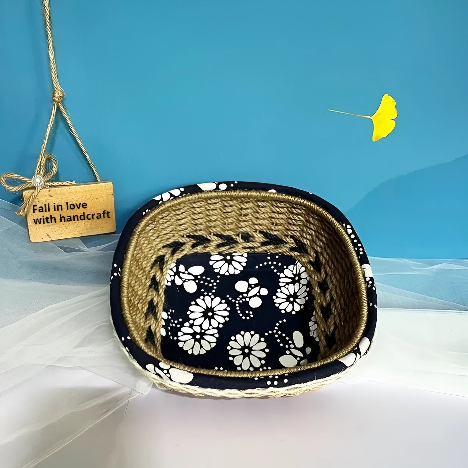 Blue square plastic hand-woven storage basket on a wooden table.
