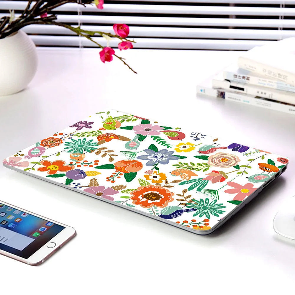 Plastic hard shell case with floral pattern for Apple MacBook Air and MacBook Pro laptops.