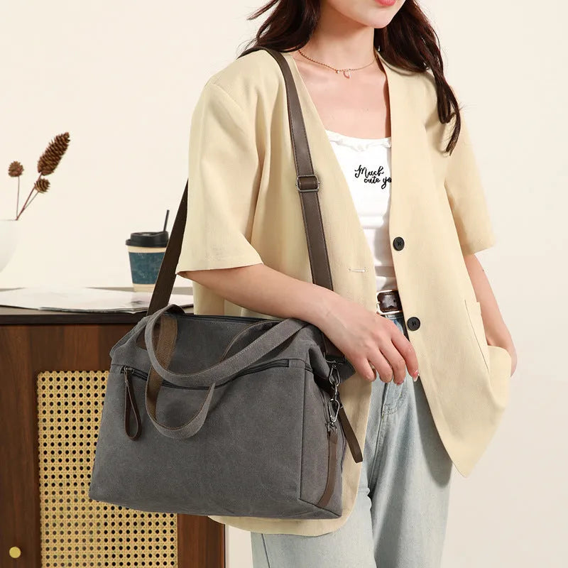 Retro style soft canvas shoulder bag for women in a horizontal square shape with internal organisers.
