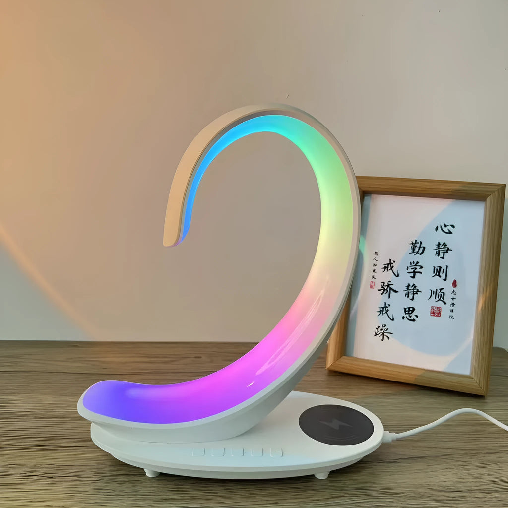 White swan-shaped desktop wireless charger with Bluetooth speaker and colourful atmosphere lighting