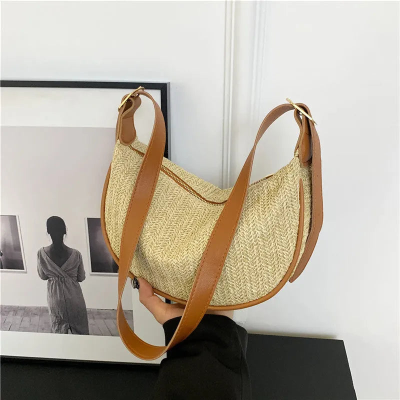 Women's woven straw crossbody bag showing internal phone pocket and file compartment in corrugated black colour