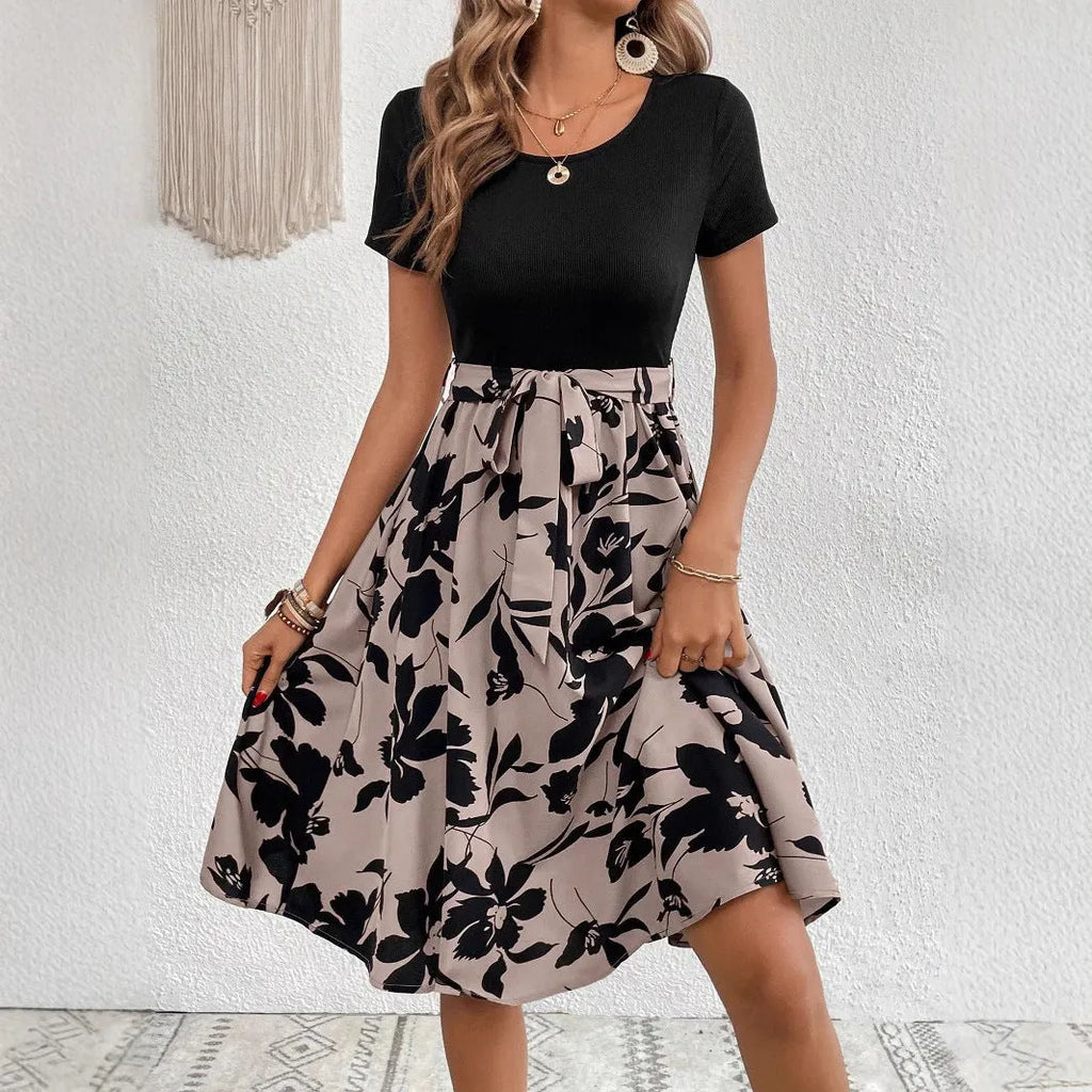 Khaki women's A-line dress with floral print and lace-up shoulder straps on a hanger.
