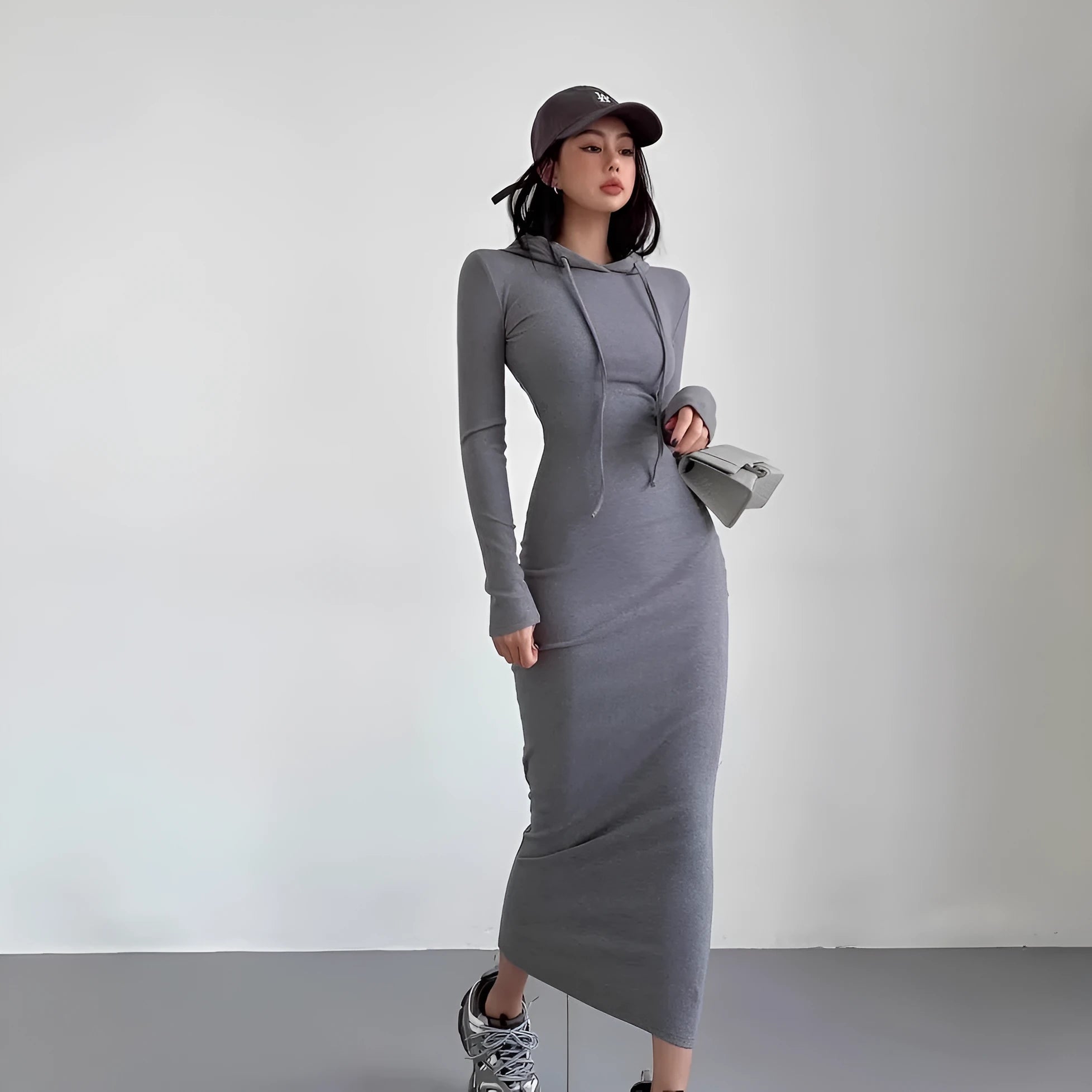 Women's grey hooded long sleeve sheath dress with a high waist on a model.
