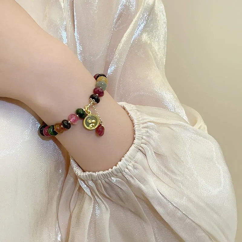 Handmade colourful tourmaline abacus bracelet with rabbit pendant charm on wrist