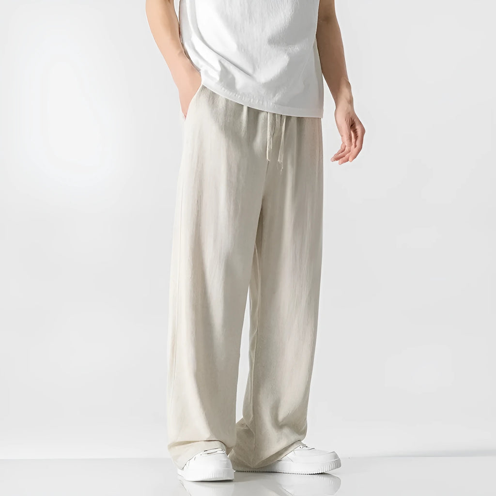 Men's beige cropped linen trousers with a drawstring waist and straight-leg casual style on a hanger.