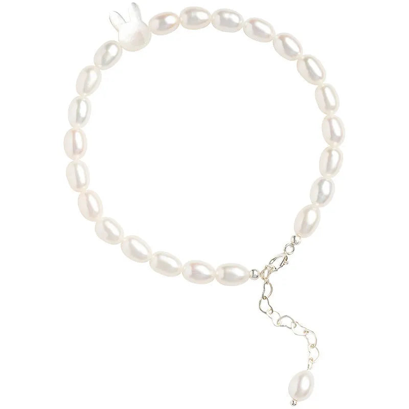 White shell bead bracelet with silver rabbit charm on elastic string
