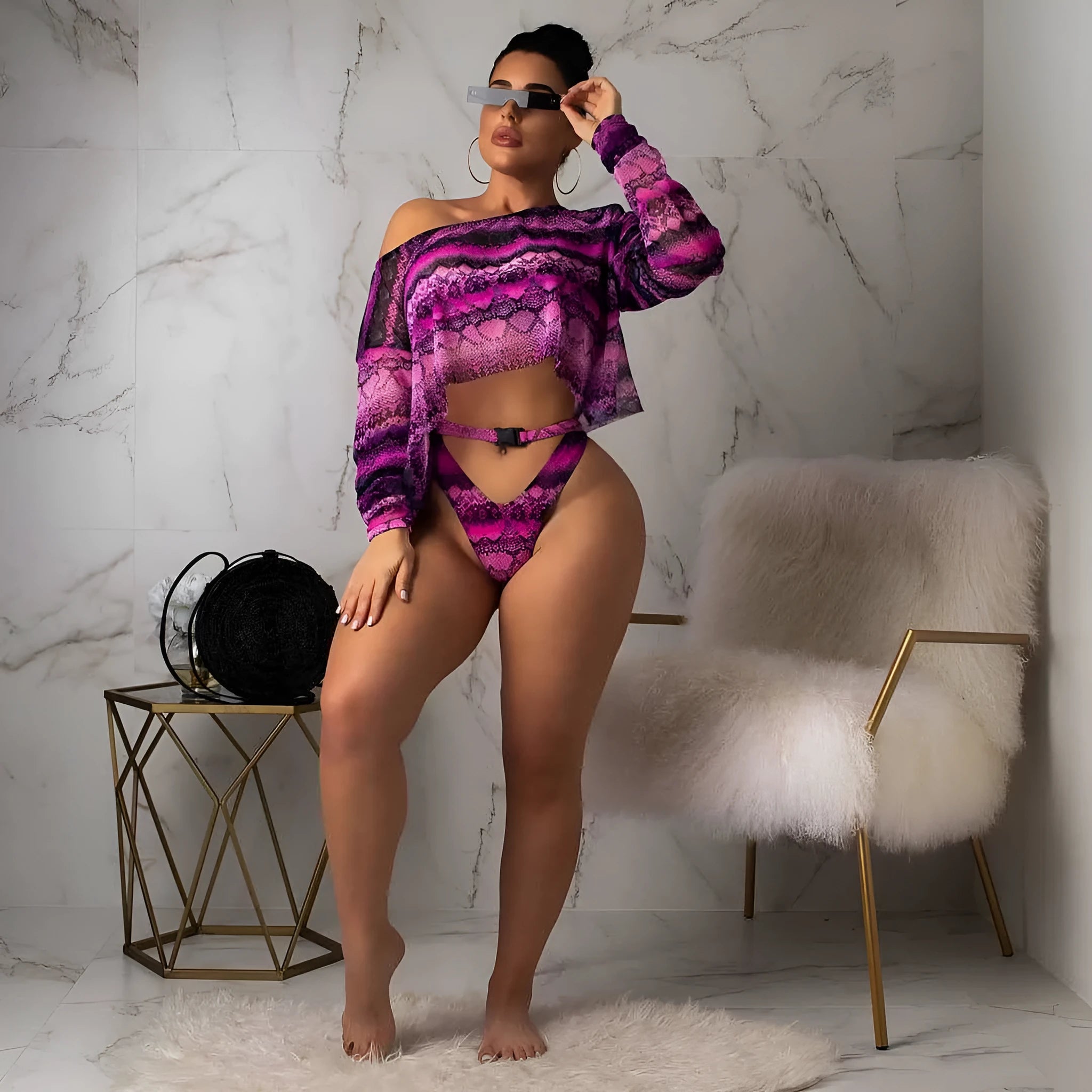 Women's snakeskin print polyester three-piece bikini suit showing long sleeve top, shorts and matching bottoms