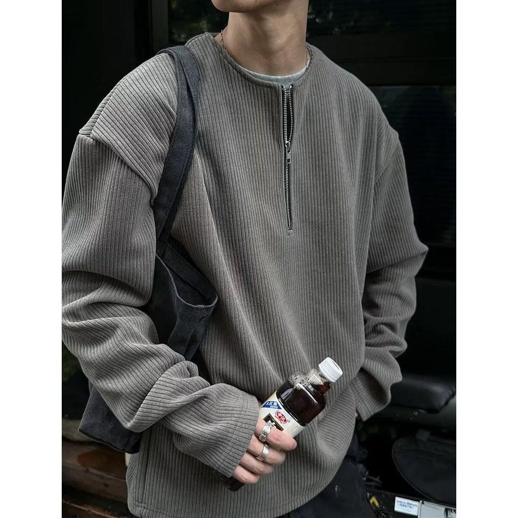 A solid colour loose pullover top with long sleeves, shown in apricot, grey and black.