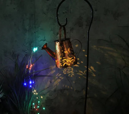 Solar-powered iron garden lamp with a tapered butterfly design in warm white.