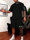 Man wearing a blue printed short-sleeve top and matching shorts from a quick-dry sports set.