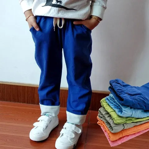 Orange cotton and linen cropped trousers for children with elastic waistband