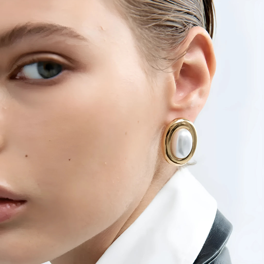 A pair of stainless steel vintage pearl stud earrings with a silver-tone electroplated finish.