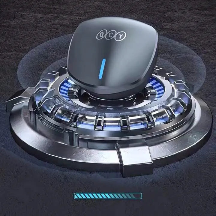 Grey QCY-G1 wireless in-ear gaming headset and its portable charging case on a table.