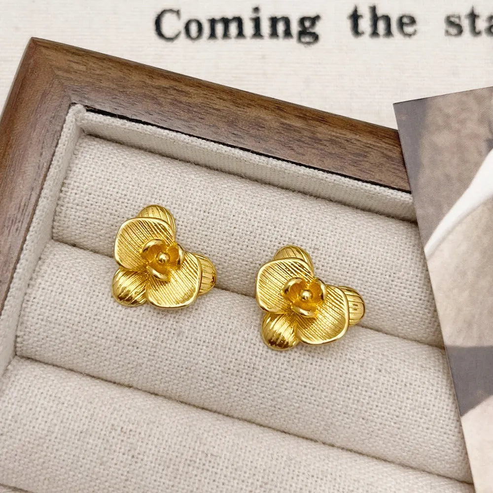 Retro style flower earrings for women in gold or silver finish with petal detailing