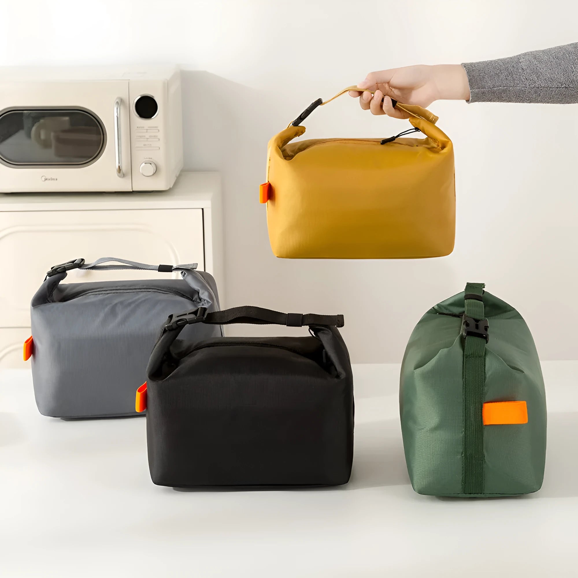 Japanese style insulated lunch bag in Oxford cloth shown in one of four colours: Army Green, Black, Grey, or Yellow.