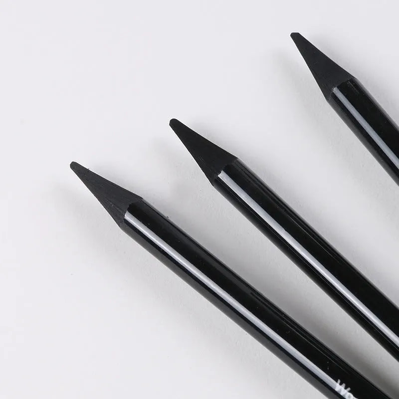 Set of six graphite pencils and three carbonized pencils with wooden shells on suction card packaging