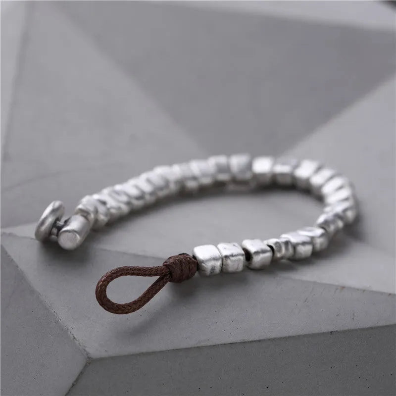 Handmade women's bracelet with irregular silver squares on wooden beads and elastic band