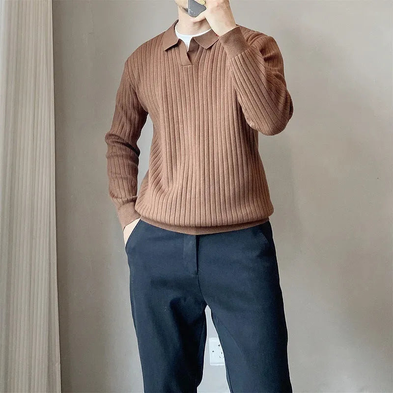 Man wearing a loose grey striped knit sweater with a lapel, long sleeves, and textured fabric.