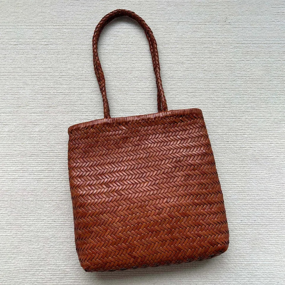 Brown woven leather tote bag with three-dimensional pocket and shoulder strap