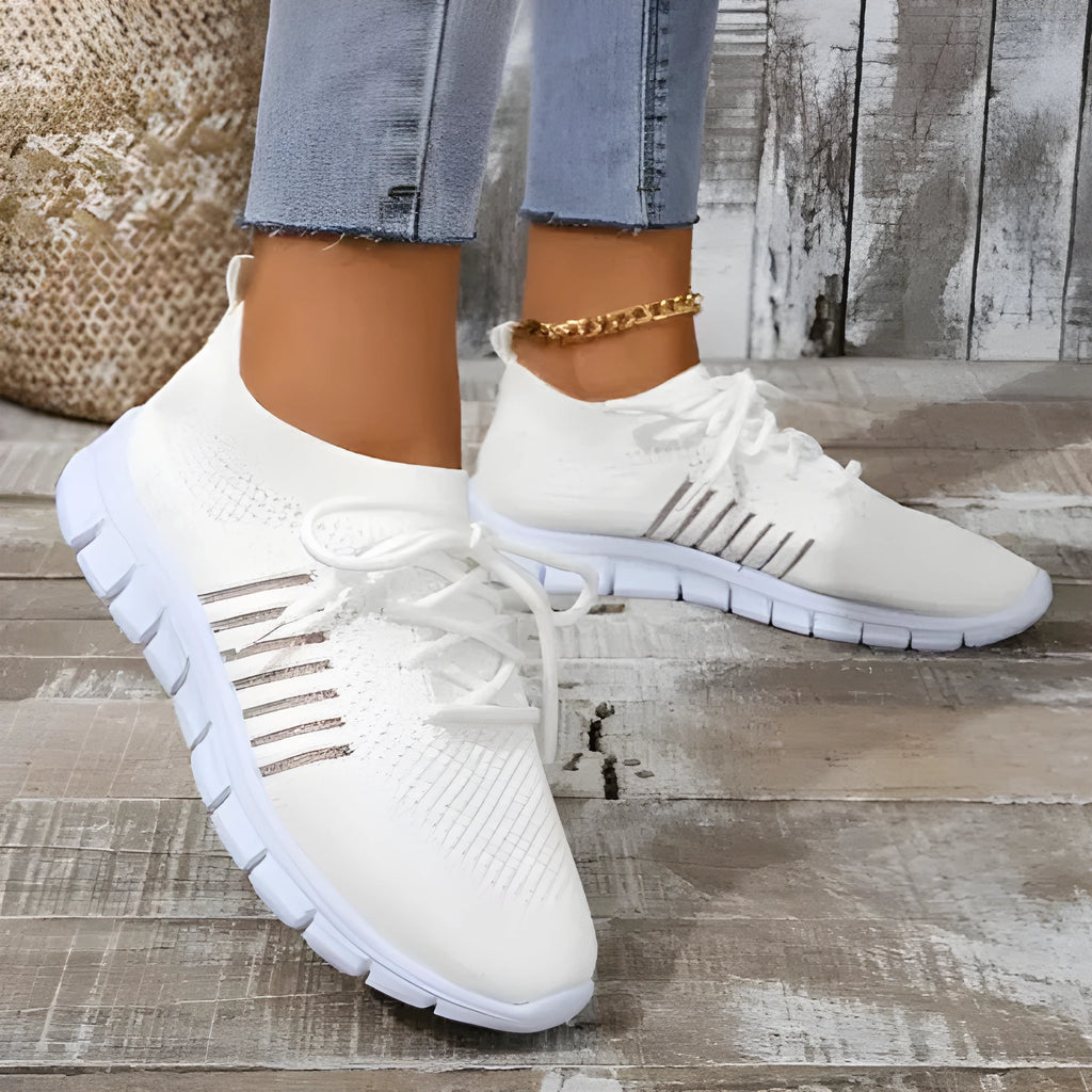 Women's breathable lace-up sneaker in a low-top style with a flat rubber sole.