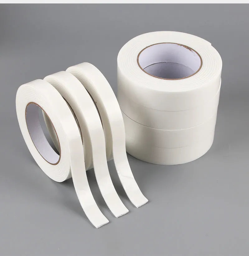 Roll of 3mm thick white foam double-sided adhesive tape showing its spongy core and strong adhesive on both sides.