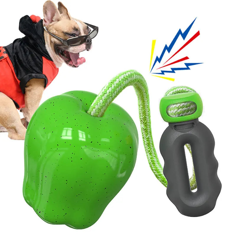 Green plastic dog toy shaped like an apple, functioning as a food-dropping ball and molar chew.