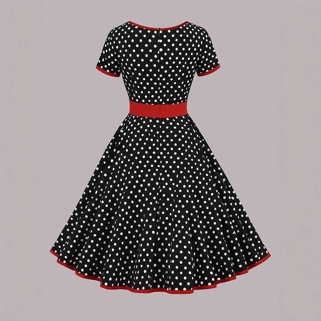 Women's multicolour polka dot pleated dress with a square collar, short sleeves, and a front zip fastener.