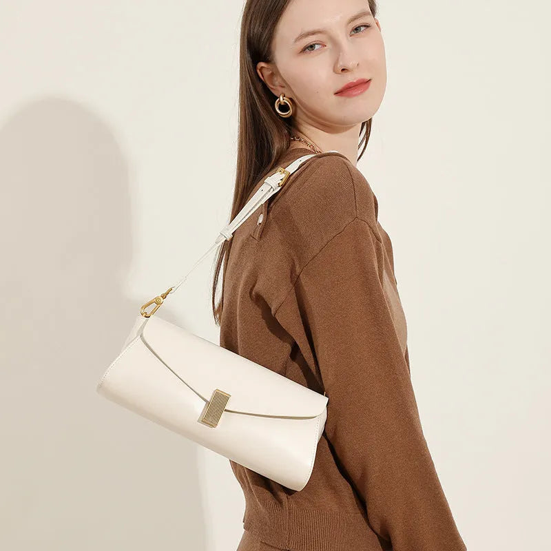 A pillow-shaped women's cowhide leather cross-body bag with a clamshell opening, shown in a choice of colours.