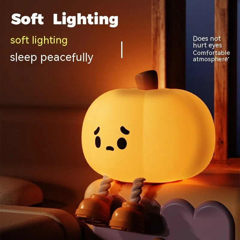 Soft orange silicone pumpkin-shaped night light with a warm glowing LED centre