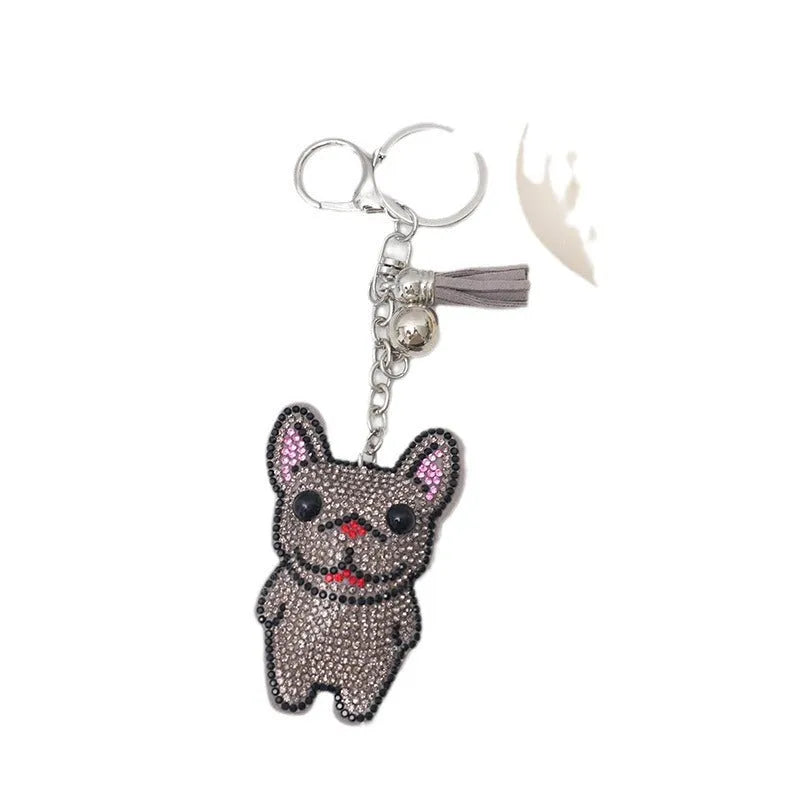 Cartoon dog alloy keychain pendant with rhinestones and bag tassel in caramel colour.