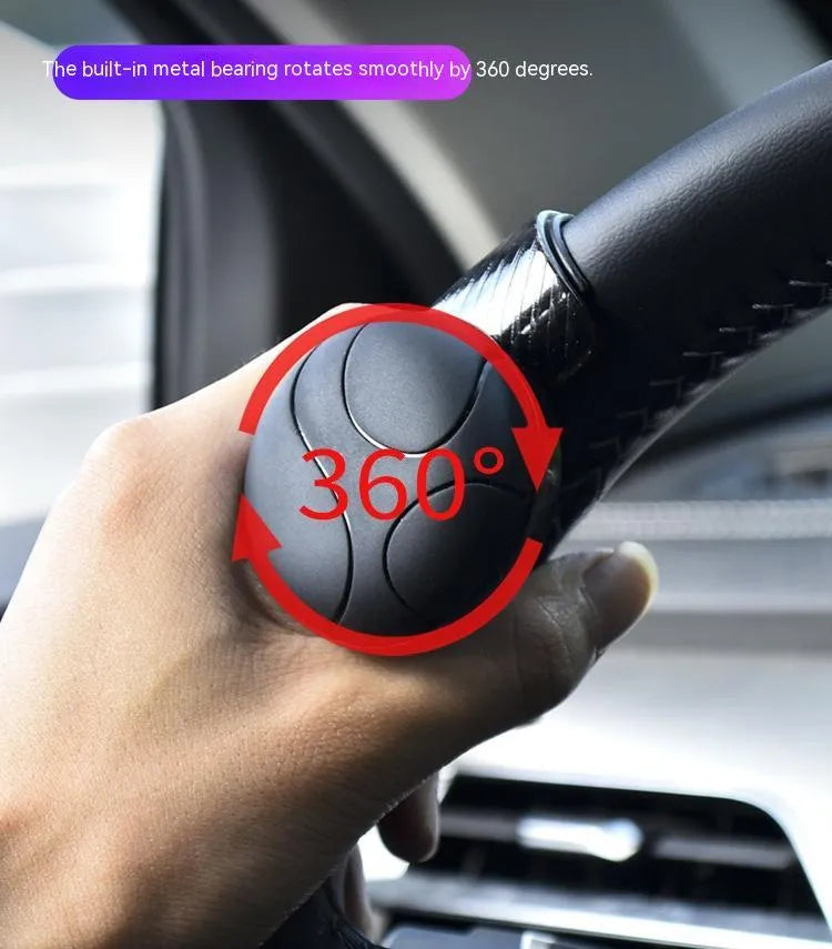 Black and blue steering wheel assist balls with silicone grip, showing approximate 9cm by 6cm size.