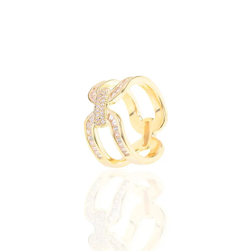Round copper scarf ring with electroplated gold finish, geometric shape, on a silk scarf