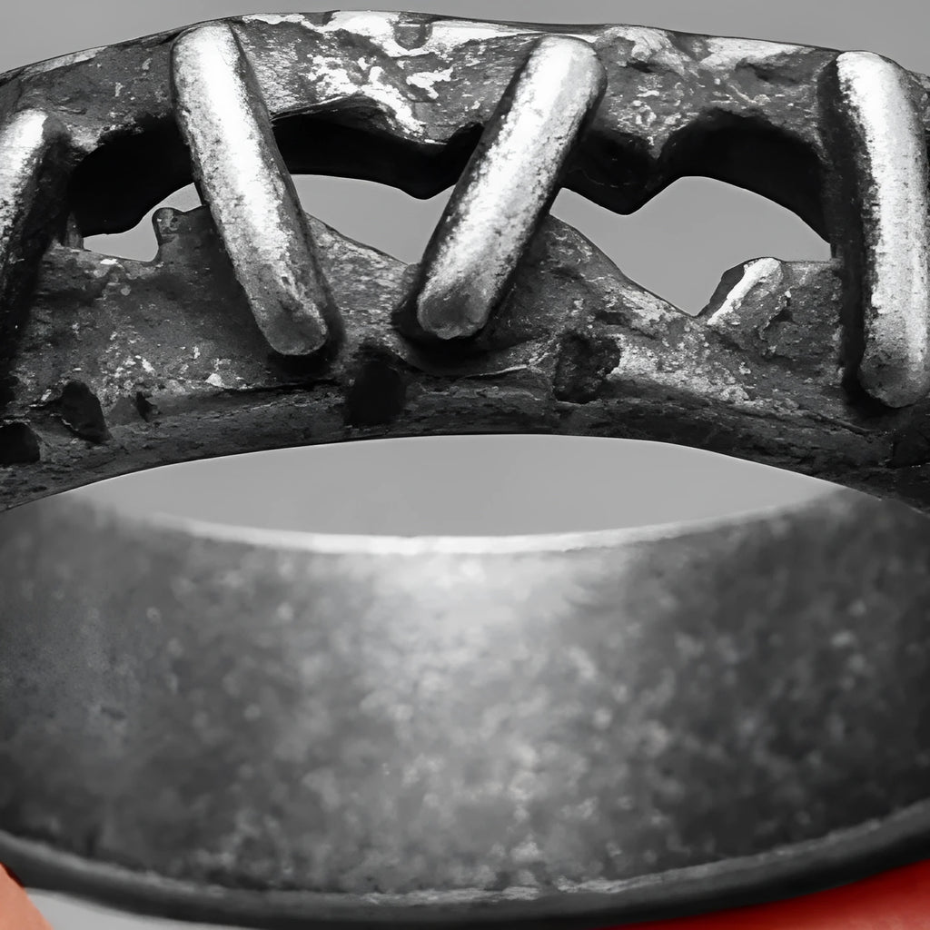 Stainless steel double ring with punk stitching style design on a finger.