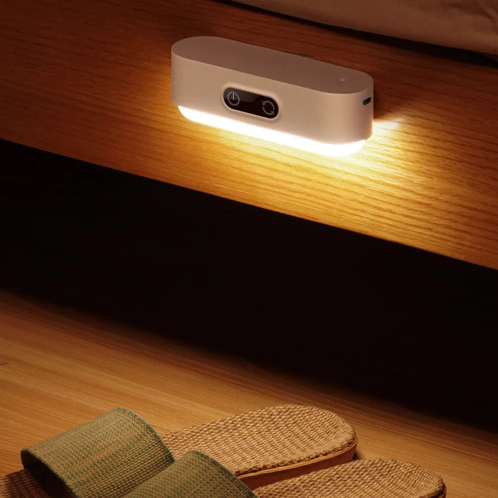 White USB rechargeable magnetic LED night light with touch controls on a metal study cabinet.