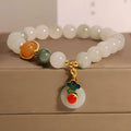 Close-up of a women's ice jade bracelet with a xiangyun peace buckle and pearl detail.