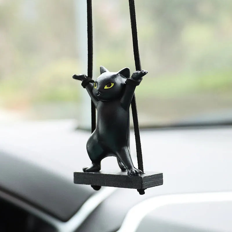 Cartoon-style resin cat pendant for car interior decoration with adjustable rope.