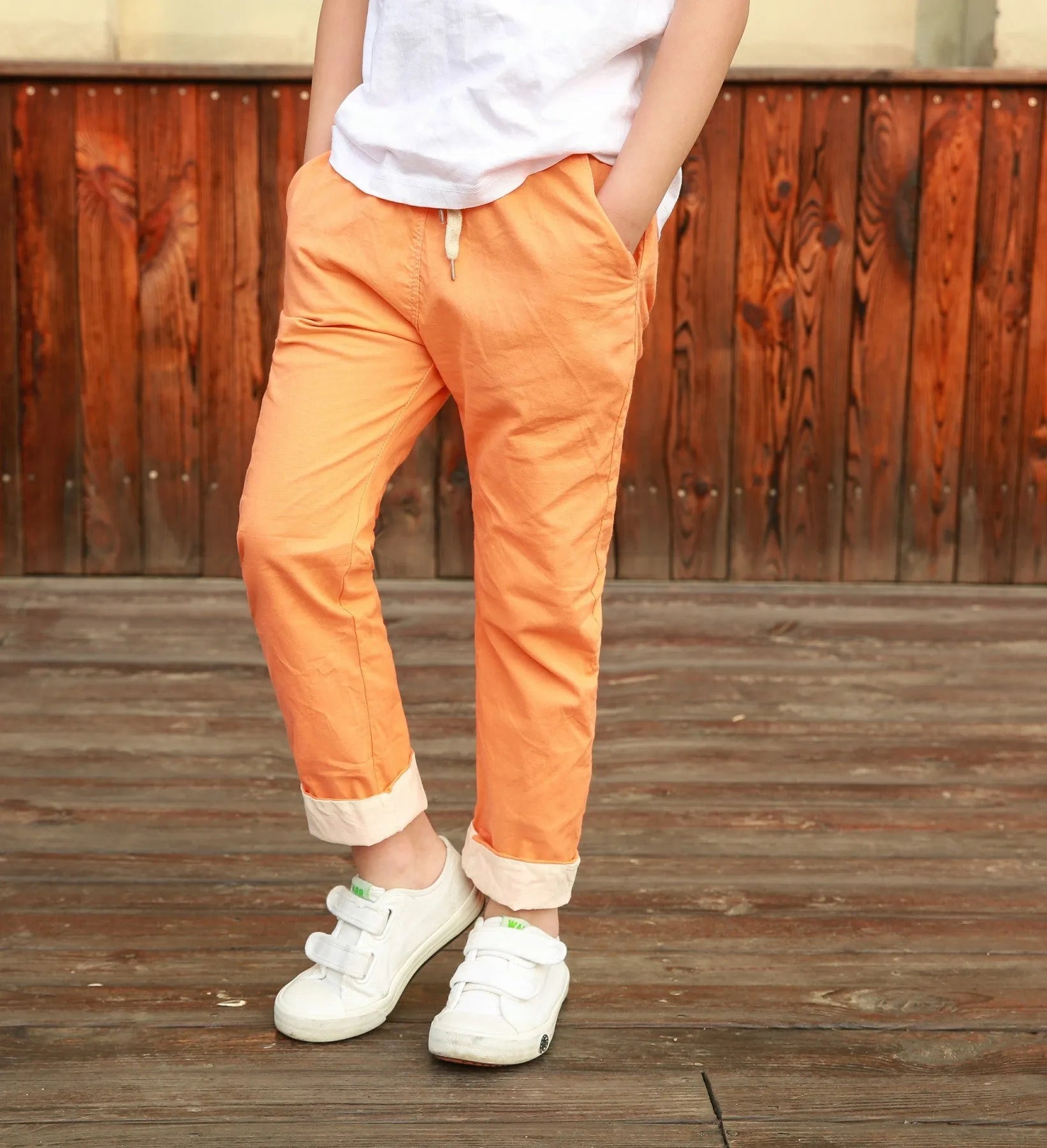 Orange cotton and linen cropped trousers for children with elastic waistband