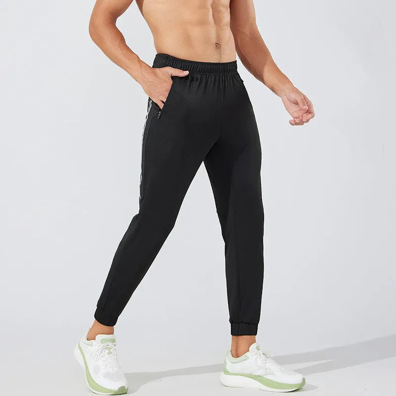 Man wearing black mid-waist polyester running pants for exercise.