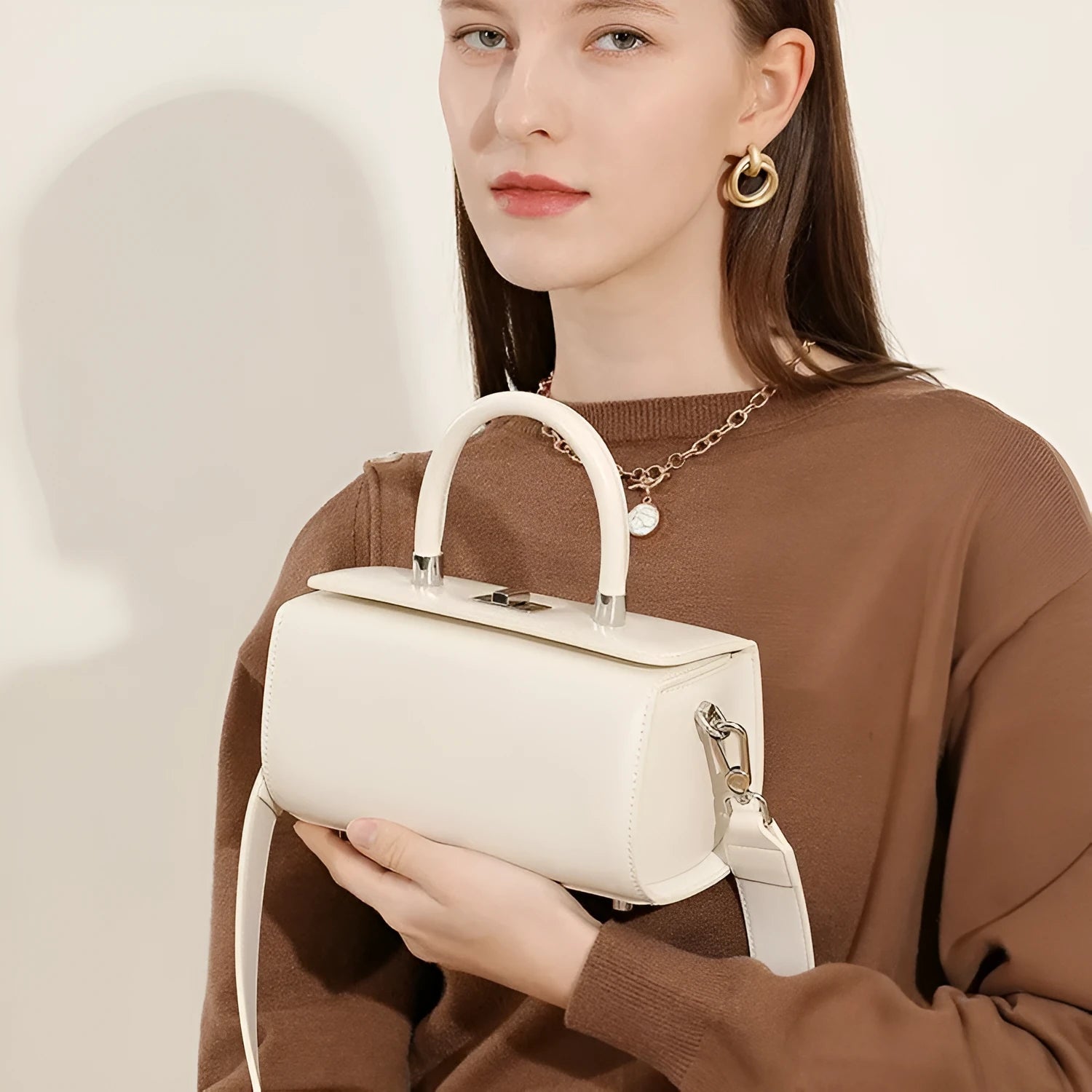 Brown genuine cowhide leather women's crossbody bag with clamshell opening shown open.