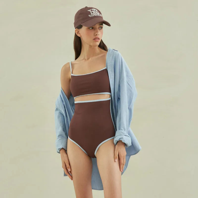 Brown women's one-piece swimsuit with triangle top design on a mannequin