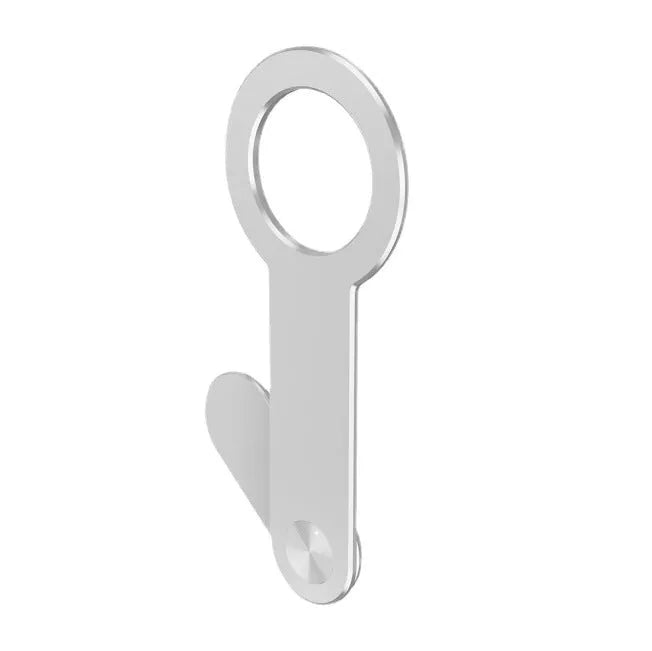 Metallic silver aluminium alloy magnetic phone holder for iPhone on a desk.