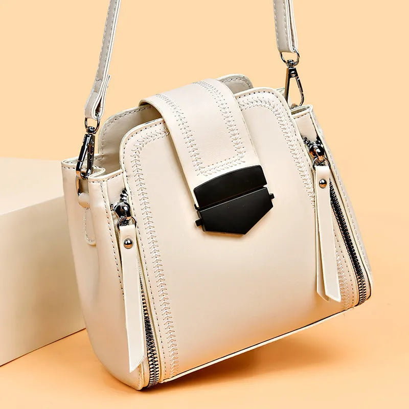 Small square vertical handbag in soft textured PU leather with sewing thread detail.