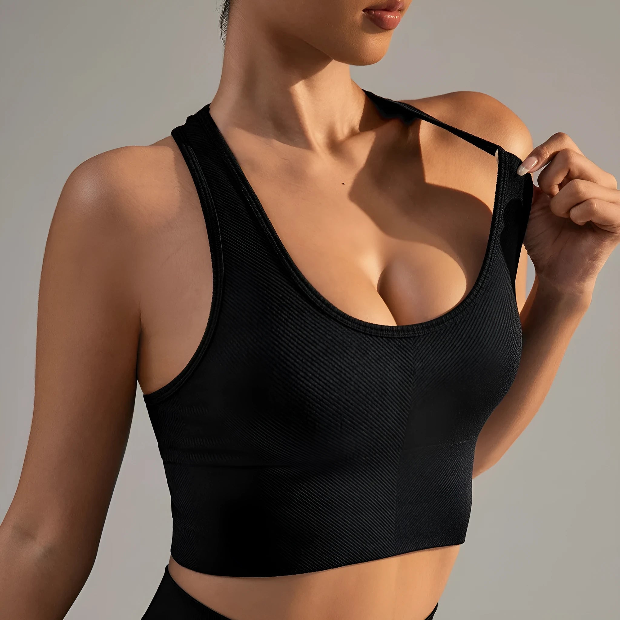 Black women's cross-back sports bra with moulded cups on a mannequin.