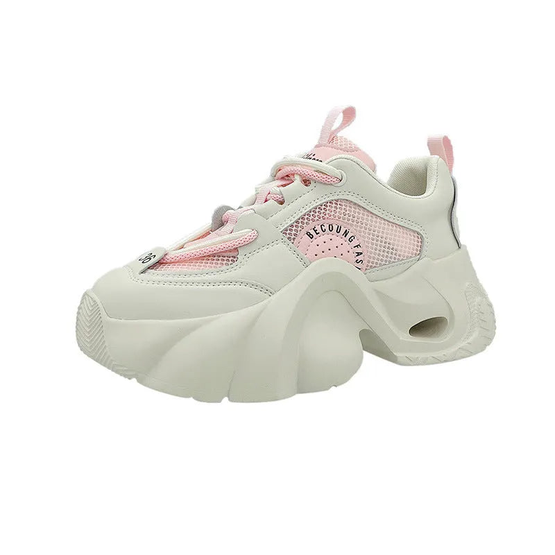 Women's pink sneakers with thick soles, cross shoulder straps, and a breathable mesh lining on a white background.
