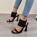 Women's black high heel sandals with elastic straps and rubber sole