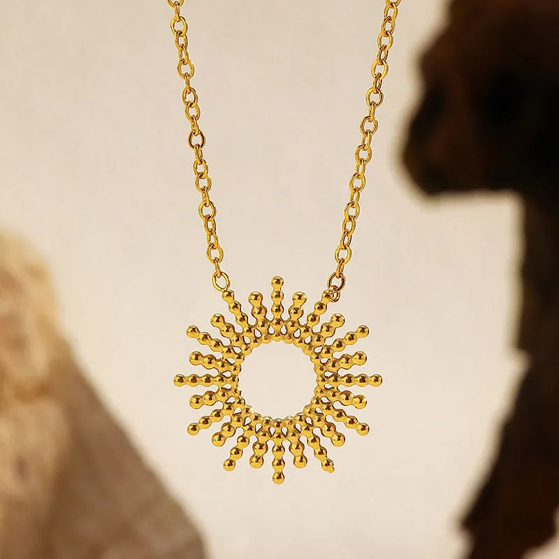 Gold-coloured jewellery set with matching geometry pendant necklace and chain bracelet