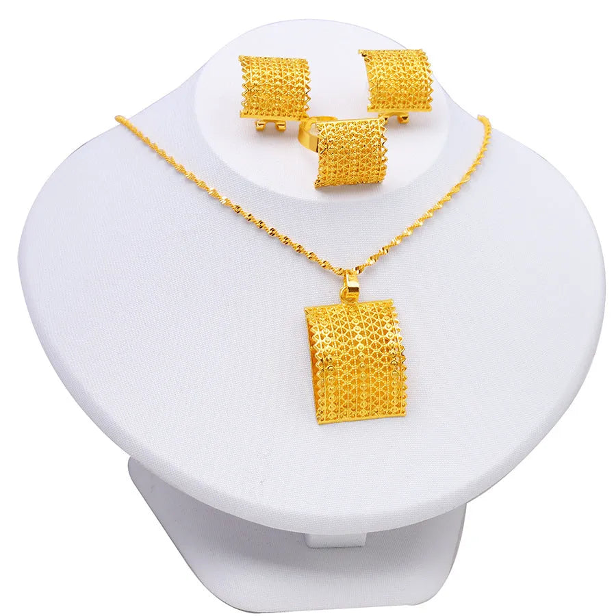 Gold tone wedding jewellery set showing necklace, earrings and ring on display