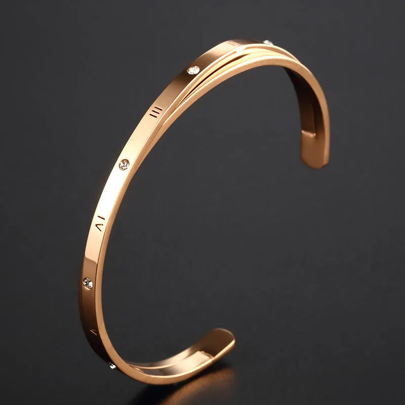 Women's open-ended stainless steel bracelet with inlaid zircon stones in a choice of rose, steel, or gold finish.